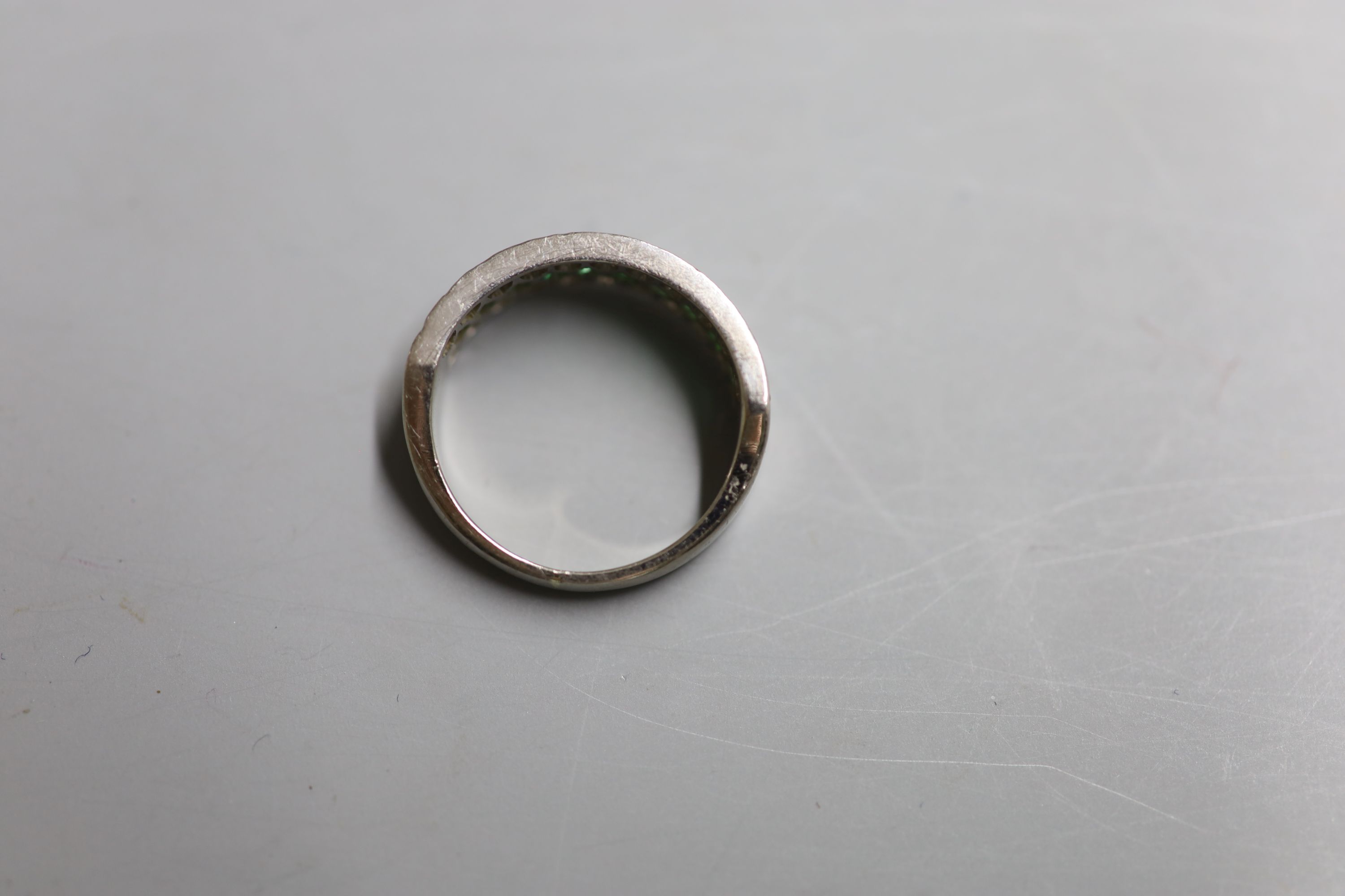 A modern 18ct white metal, emerald and diamond three row half hoop ring, size Q, gross 6.7 grams.